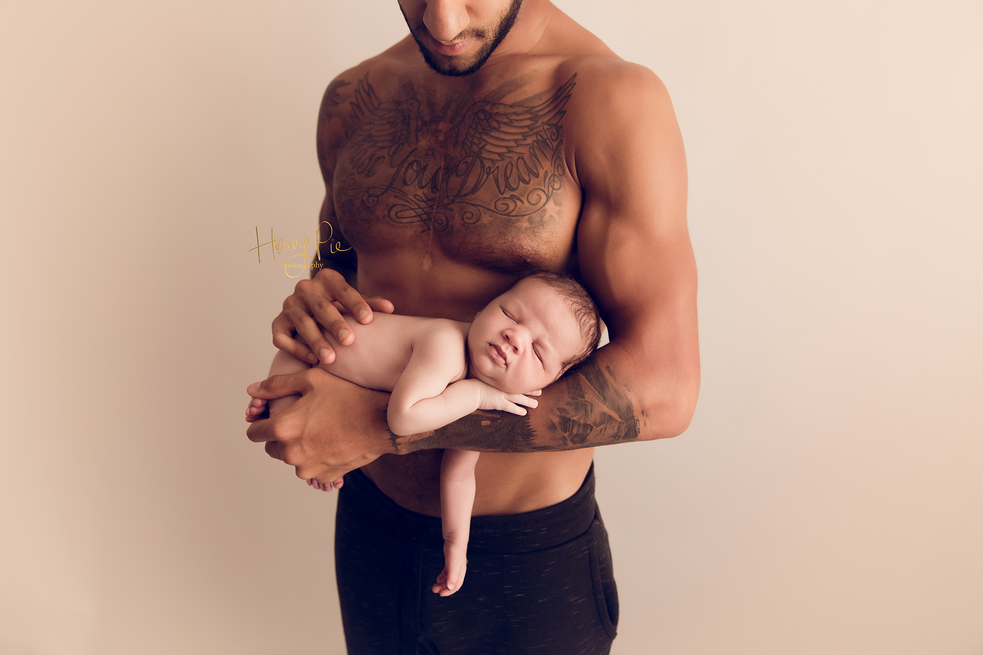 Connor Goldson newborn baby boy sleeping in his daddys arms during Sussex photoshoot