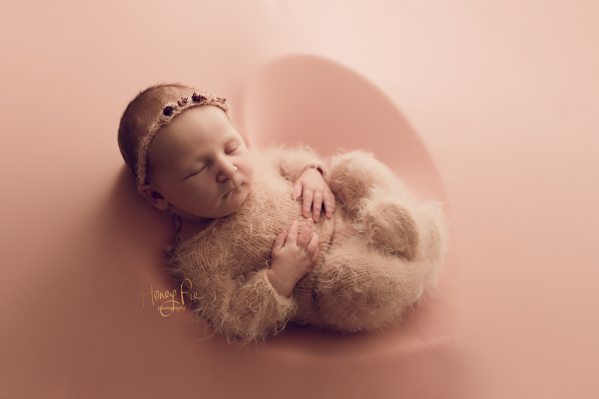 Sleeping newborn baby in a heart shaped bowl during photoshoot in Sussex