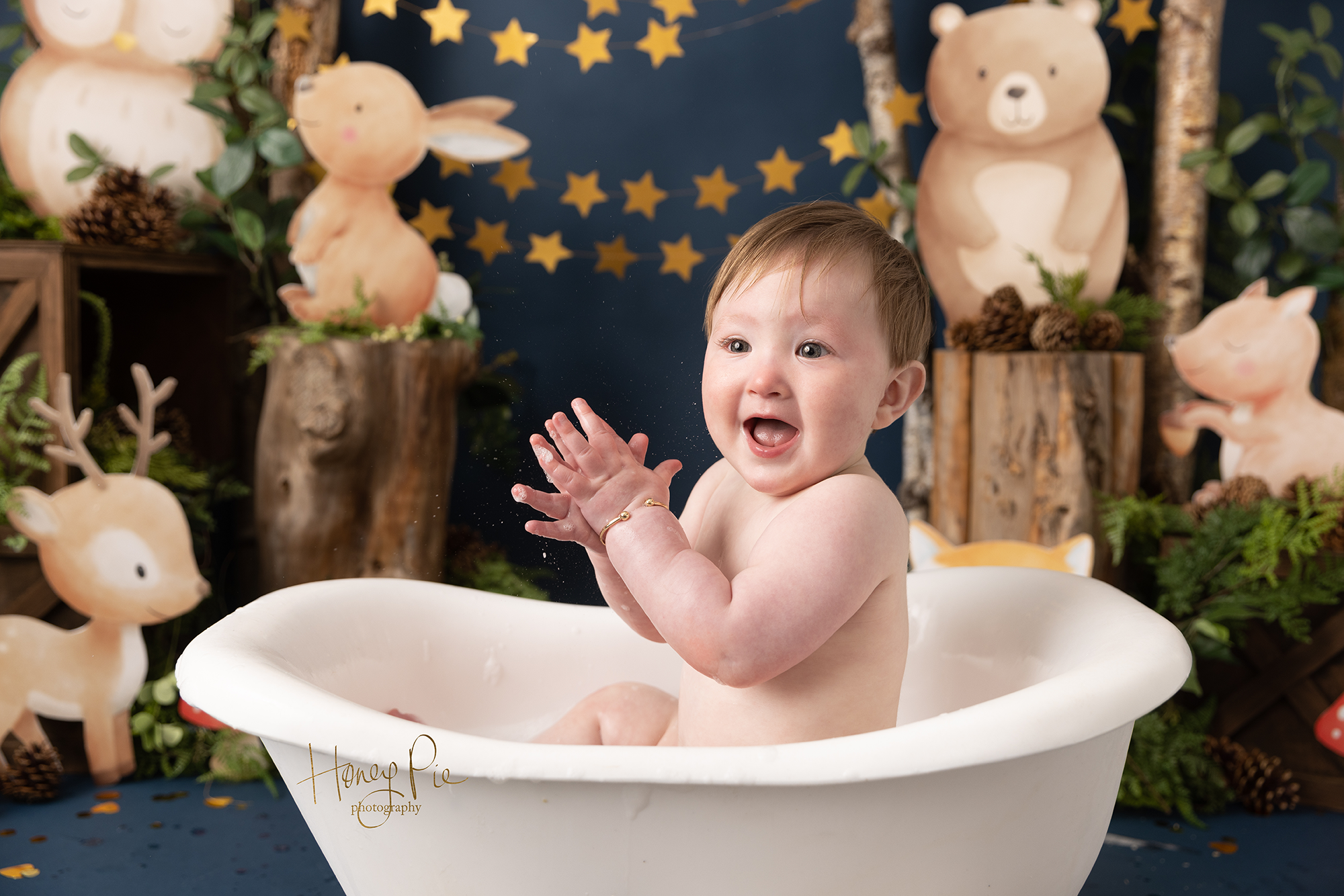 Baby happy clapping in a bubble bath