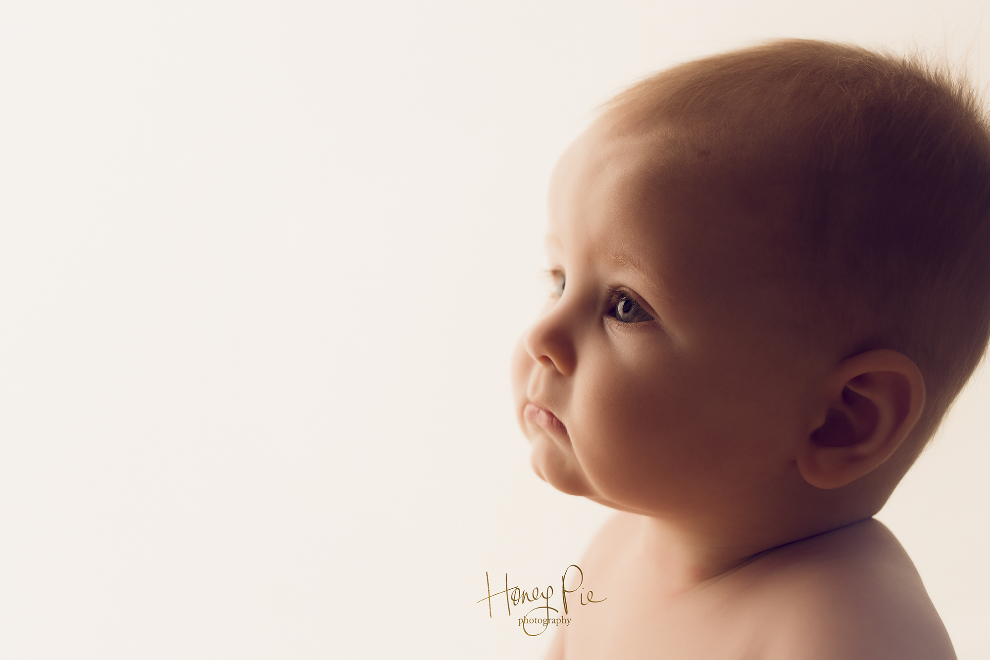 Baby contemplating & staring off to the distance during her baby photography session in Brighton